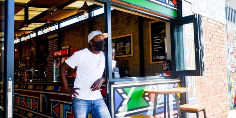 Trevor Leso stands outside of his coffee shop, Vilakazi Espresso, looking outside an empty Vilakazi Street. Photo by Tebogo Mokwena/VUTIVI
