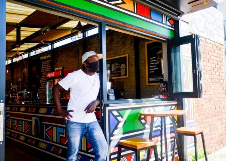 Trevor Leso stands outside of his coffee shop, Vilakazi Espresso, looking outside an empty Vilakazi Street. Photo by Tebogo Mokwena/VUTIVI