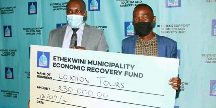 Gcinokuhle Dube receiving a cheque from eThekweni municipality