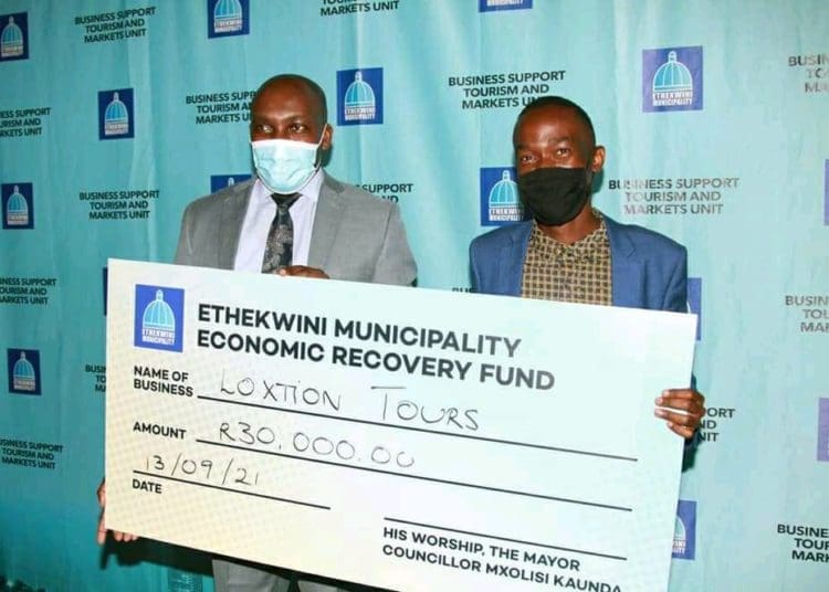 Gcinokuhle Dube receiving a cheque from eThekweni municipality