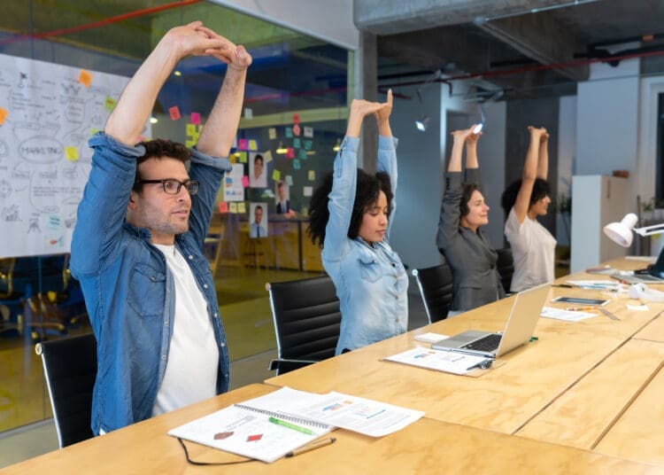 Group of Latin American Workers doing stretching exercises in a business meeting at the office - healthy lifestyle concepts
 (Group of Latin American Workers doing stretching exercises in a business meeting at the office - healthy lifestyle concepts
,