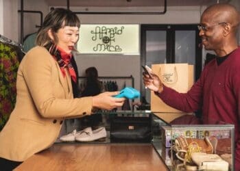 Small business owner managing stock using a digital point-of-sale system.