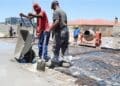Construction workers pour cement on site, reflecting the labour-intensive building industry where leaders and SMEs are calling for practical regulation that balances compliance requirements with worker protection.
Photo: SANS